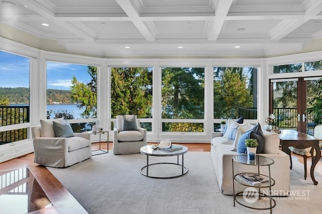 sunroom / solarium with beam ceiling, a water view, a healthy amount of sunlight, and coffered ceiling