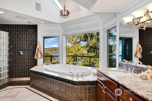 bathroom with tile patterned flooring, a notable chandelier, independent shower and bath, and vanity