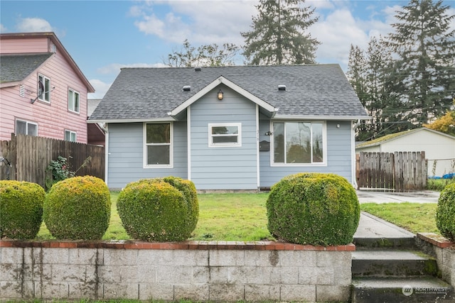 bungalow-style home with a front yard