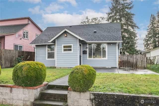 bungalow featuring a front yard and a patio area