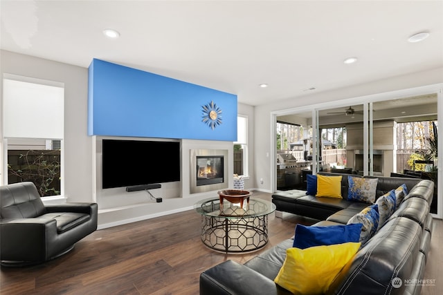 living room featuring ceiling fan and wood-type flooring