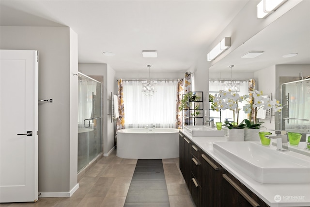 bathroom featuring shower with separate bathtub, a chandelier, and vanity