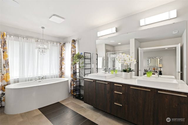 bathroom with shower with separate bathtub, a notable chandelier, and vanity