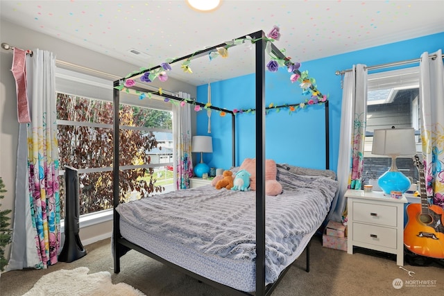 bedroom featuring multiple windows and carpet flooring