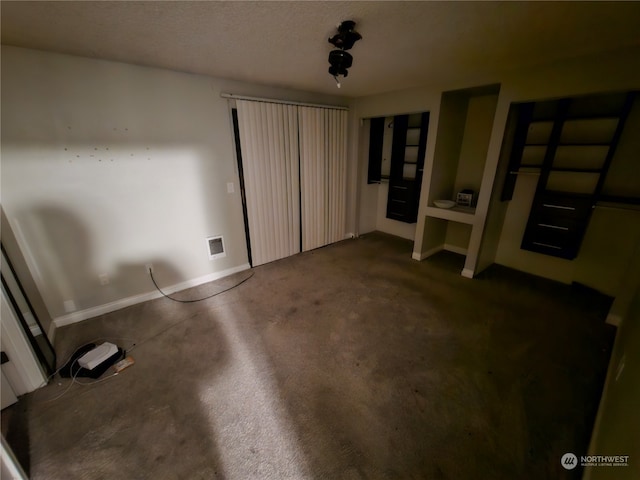 unfurnished bedroom with dark carpet