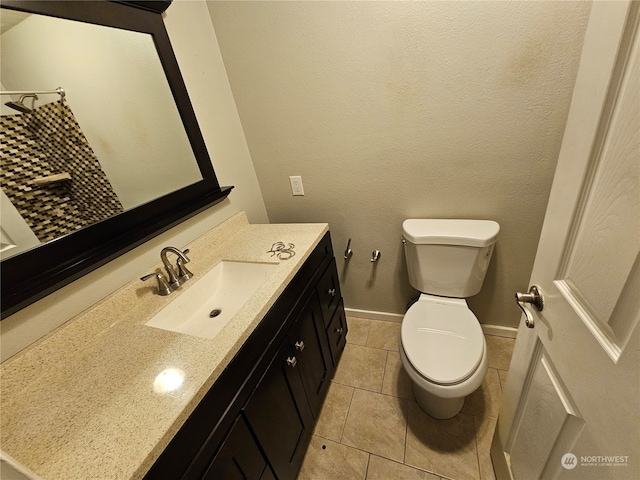 bathroom featuring vanity, toilet, and tile patterned flooring