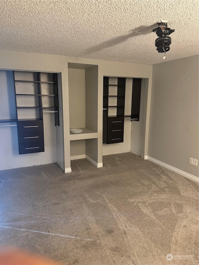 unfurnished bedroom with carpet and a textured ceiling