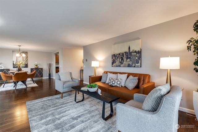 living room with dark hardwood / wood-style flooring and a notable chandelier