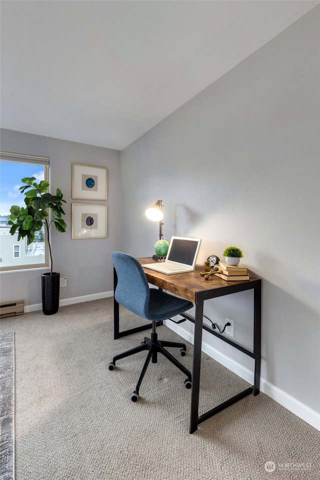 carpeted office space with a baseboard radiator