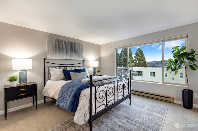 carpeted bedroom featuring a baseboard heating unit