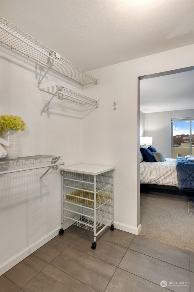 spacious closet with tile patterned flooring