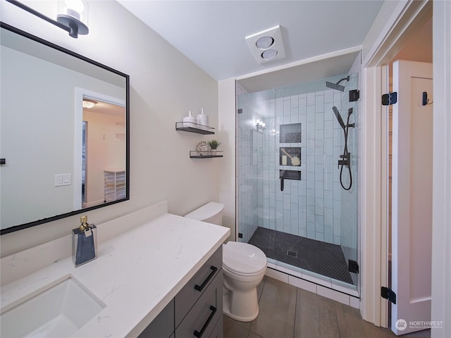 bathroom featuring vanity, toilet, and walk in shower