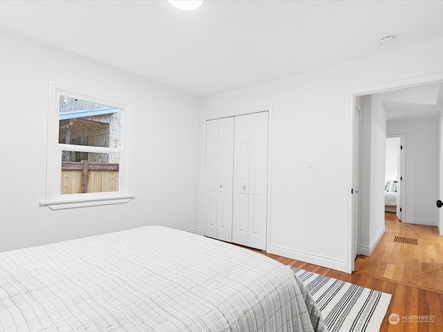 bedroom featuring hardwood / wood-style flooring and a closet