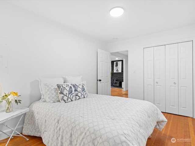 bedroom featuring wood-type flooring and a closet