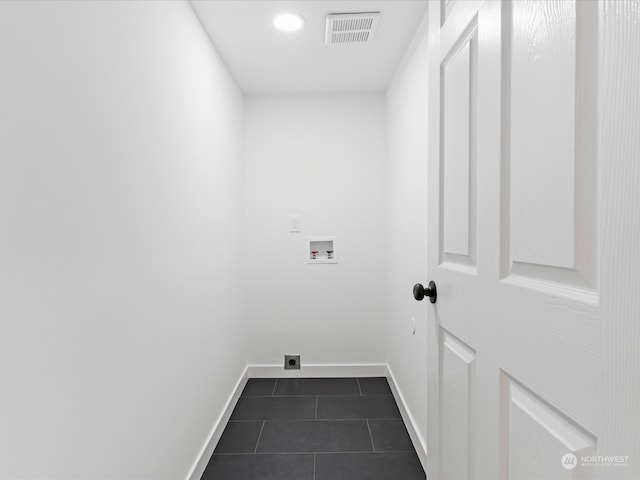 laundry room with dark tile patterned flooring, hookup for a washing machine, and hookup for an electric dryer