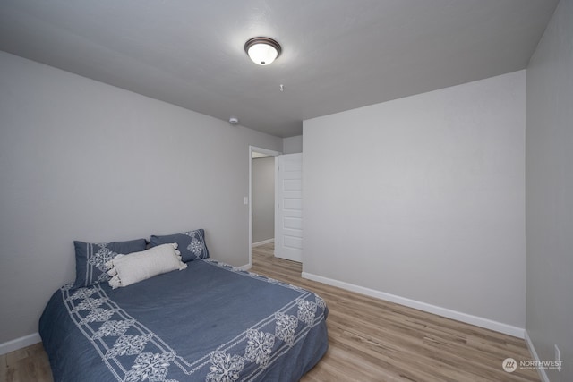 bedroom with hardwood / wood-style floors