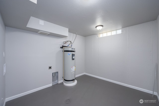 basement with electric water heater and a textured ceiling