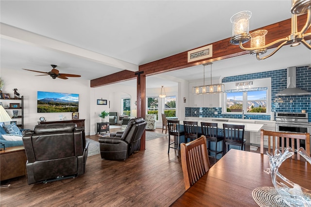 interior space with hardwood / wood-style floors, ceiling fan, and beam ceiling