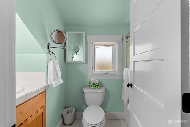 bathroom featuring toilet, vanity, and tile patterned flooring