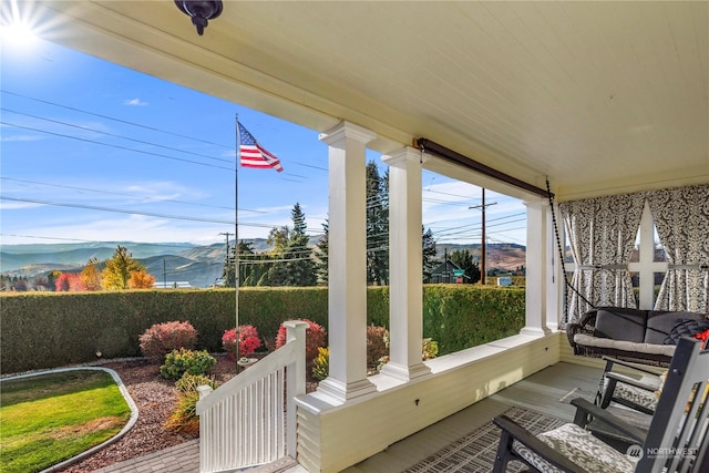 sunroom / solarium with a mountain view and plenty of natural light