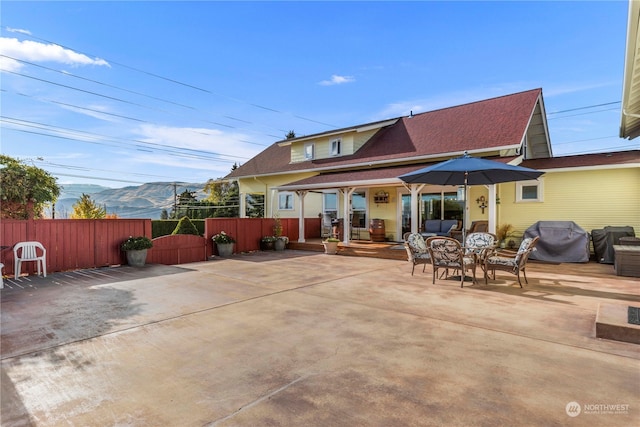 back of house featuring a mountain view and a patio