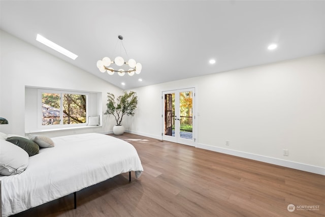 bedroom featuring recessed lighting, wood finished floors, baseboards, access to outside, and lofted ceiling with skylight