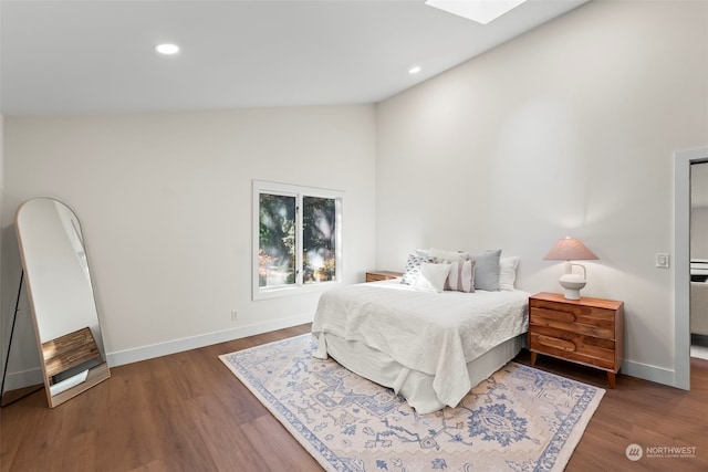 bedroom featuring dark wood-style floors, recessed lighting, and baseboards