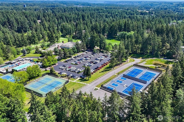 bird's eye view with a wooded view