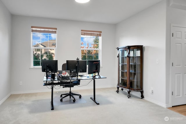 home office featuring a wealth of natural light and light colored carpet