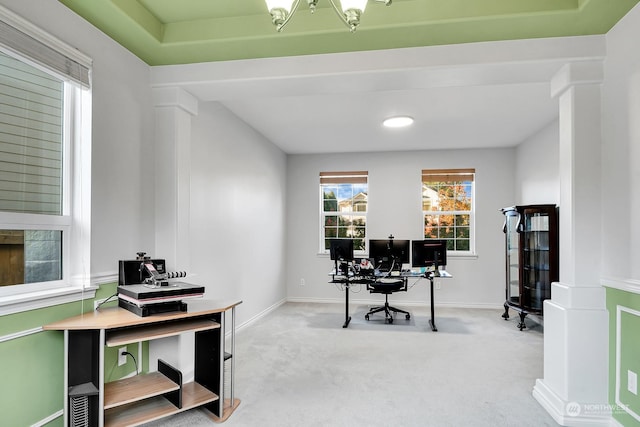 carpeted office space with decorative columns