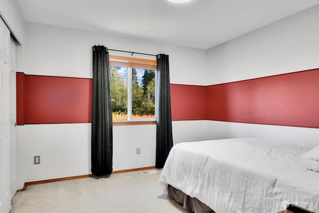 bedroom with light colored carpet and a closet