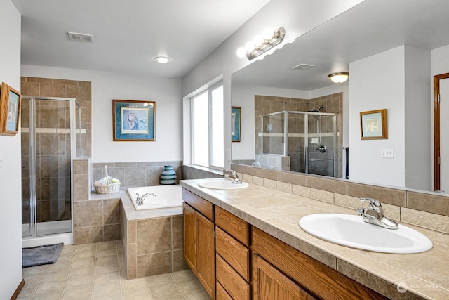 bathroom featuring tile patterned flooring, vanity, and independent shower and bath