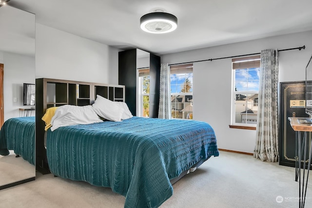 bedroom featuring carpet flooring and multiple windows