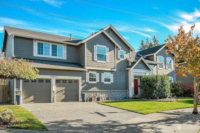 view of front of home with a front lawn and a garage