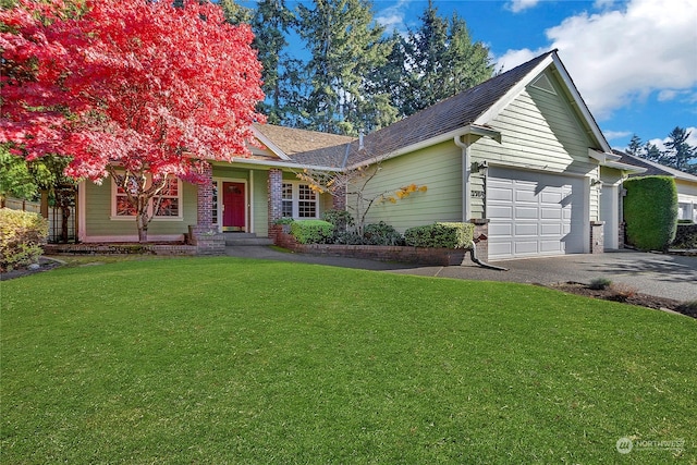 view of front of property featuring a garage and a front yard