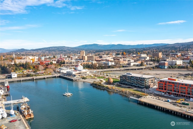 drone / aerial view with a water and mountain view