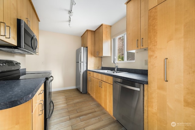 kitchen with rail lighting, sink, and appliances with stainless steel finishes