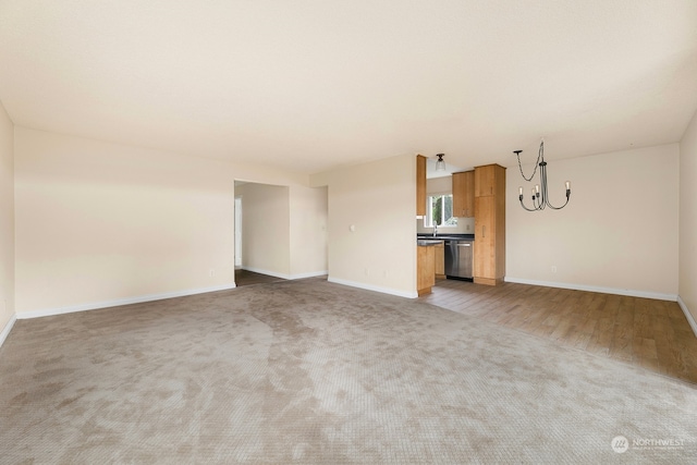 unfurnished living room with sink and carpet floors