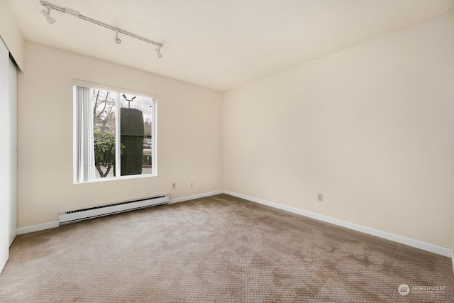 5021 Ripley Ln N Unit 112, Renton, WA 98056 - carpeted spare room featuring a baseboard heating unit, rail lighting, and baseboards