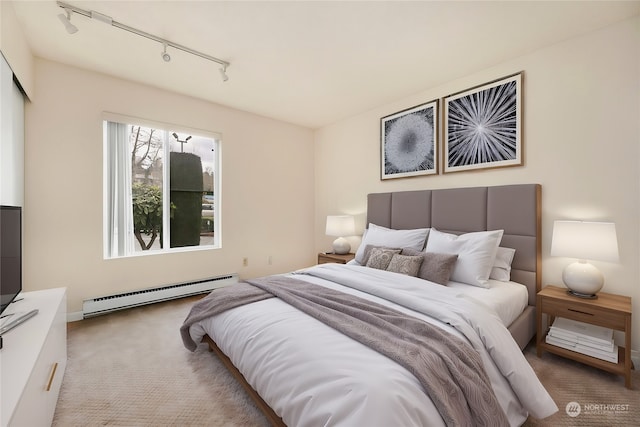 carpeted bedroom with rail lighting and baseboard heating