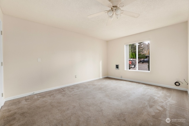 unfurnished room featuring ceiling fan, carpet floors, and a textured ceiling