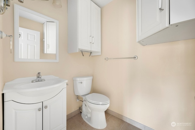 bathroom featuring tile patterned flooring, vanity, and toilet