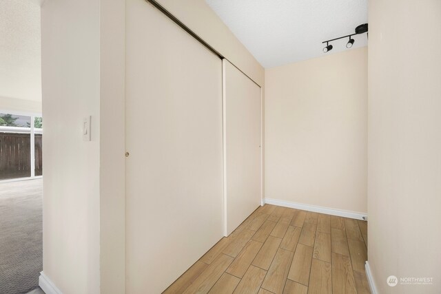 corridor with light hardwood / wood-style floors