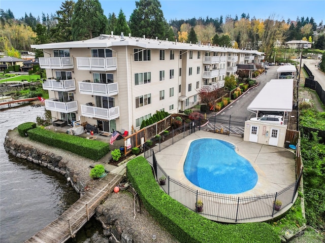 view of swimming pool featuring a water view