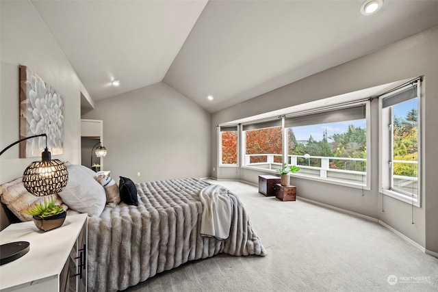 carpeted bedroom featuring lofted ceiling and multiple windows