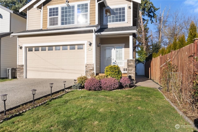 craftsman inspired home featuring a garage and a front yard