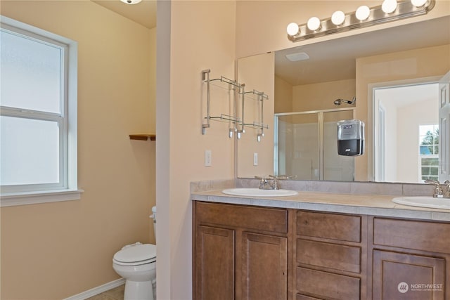 bathroom with walk in shower, vanity, and toilet