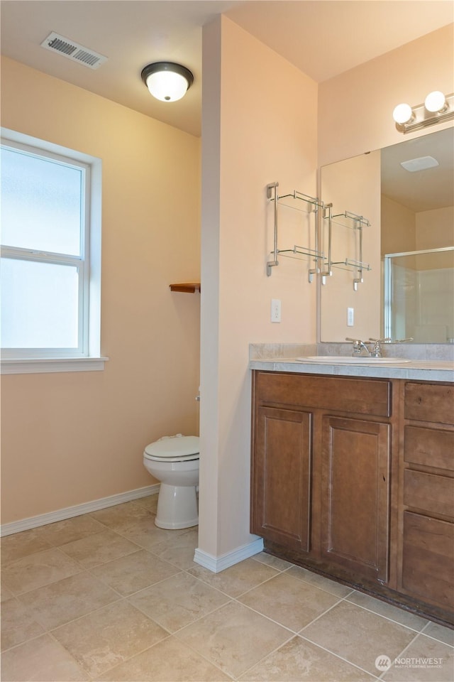 bathroom with walk in shower, vanity, toilet, and tile patterned flooring