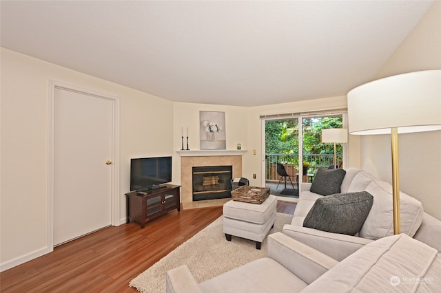 living room with hardwood / wood-style floors and a tile fireplace