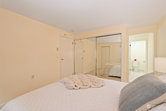 bedroom featuring ensuite bath and a closet